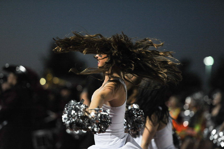 The hair of this Horizon Pom Pom girl moves in every direction during a prehomecoming game routine at Five Star North Stadium Sept. 23.